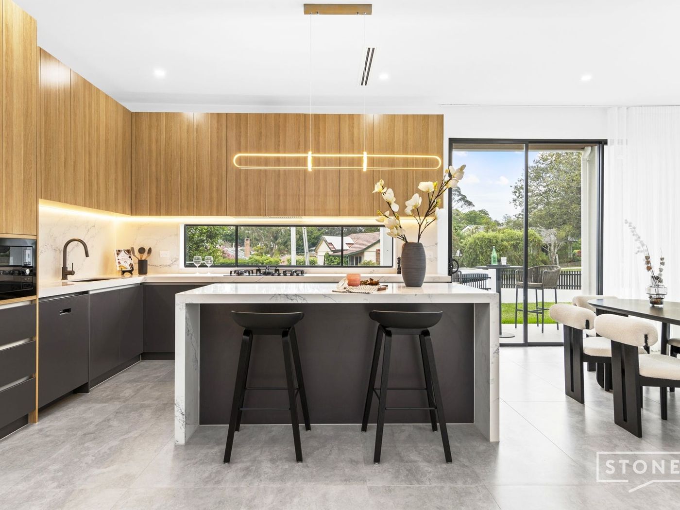 Kitchen with stone island and timber joinery